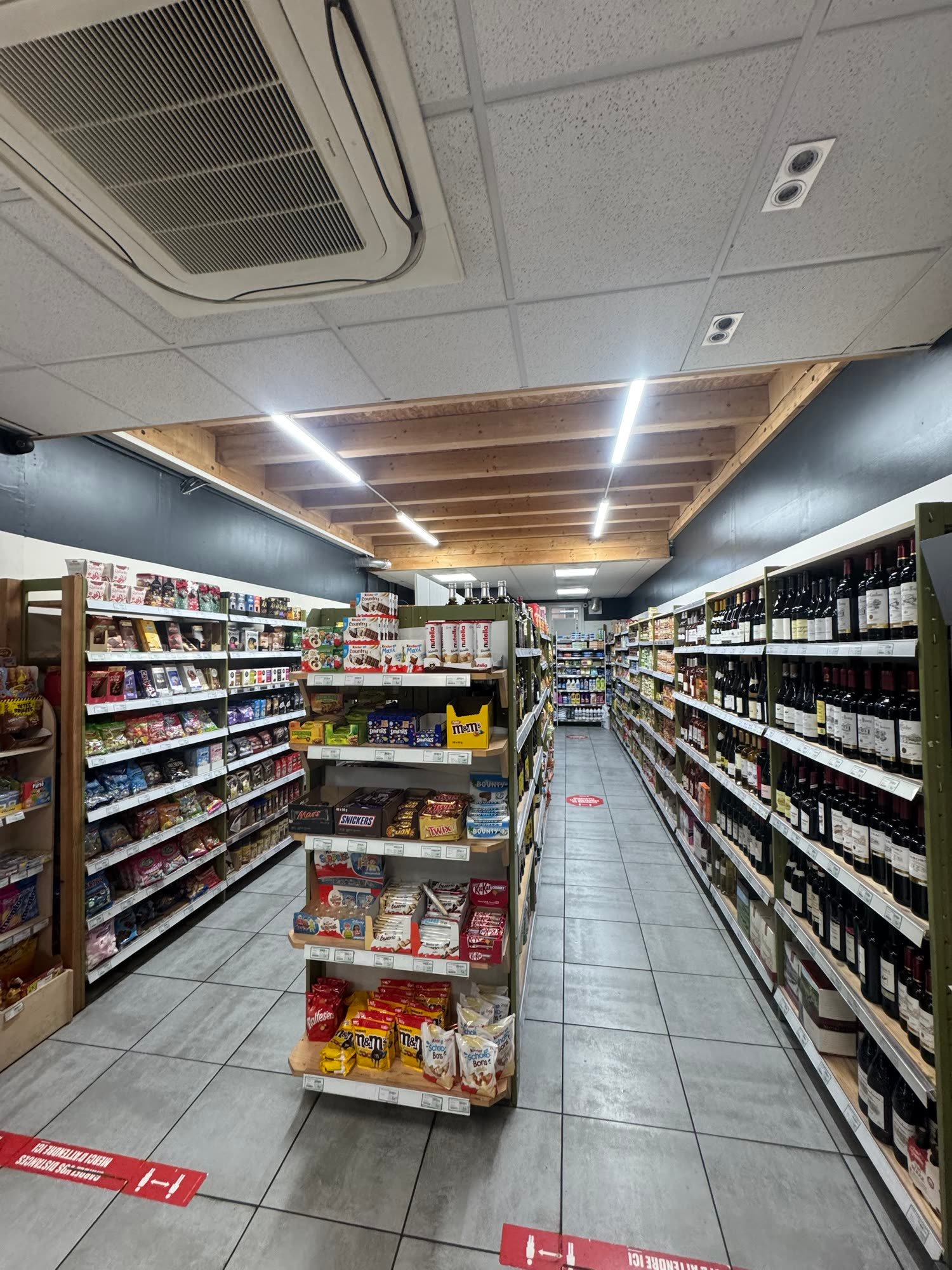 Les deux allées de confiseries et de vins sous les poutres en bois